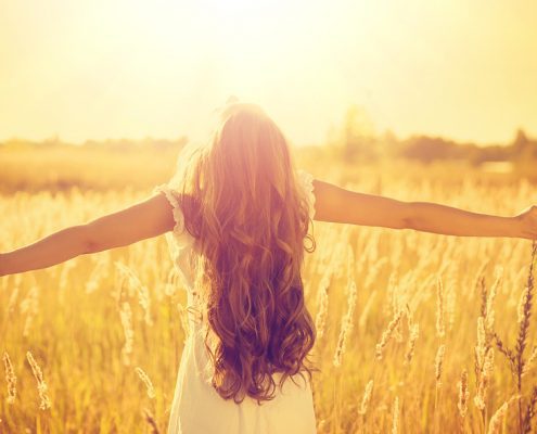 Girl with arms outstretched in nature | embracing life's challenges